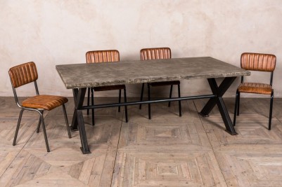 concrete-look-table-with-x-frame-base-and-arlington-chairs
